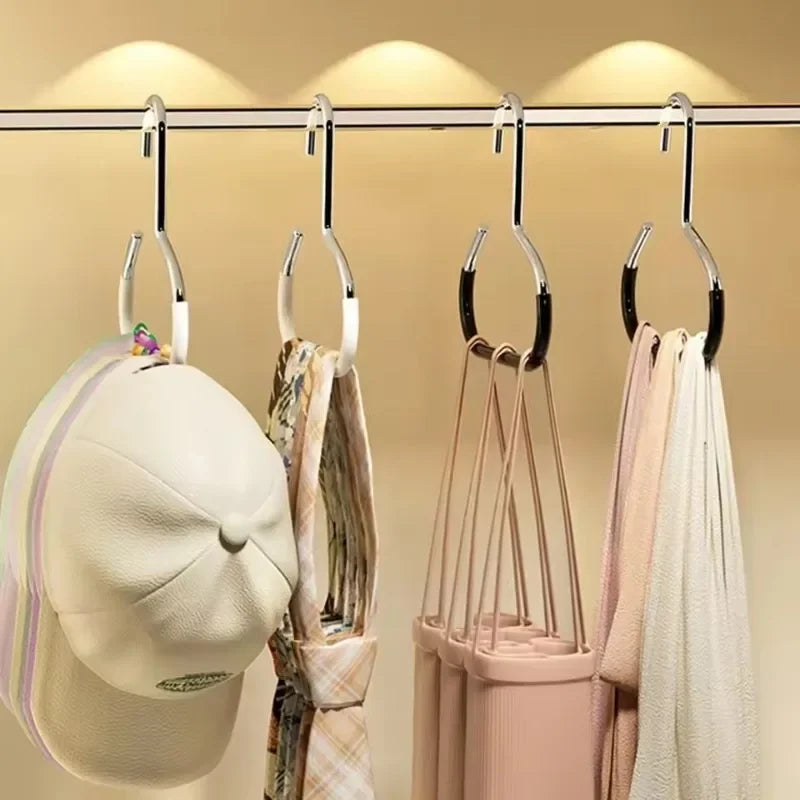 A display of various hats and bags hanging from metal rings for organization