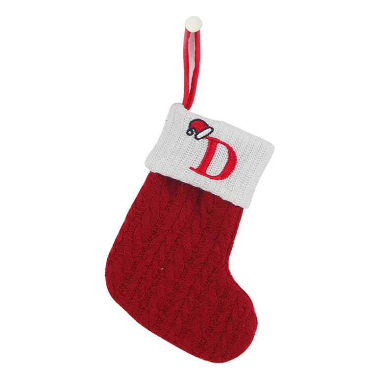 A red knitted sock with a white alphabet letter D on the toe and a red and white hanging loop.
