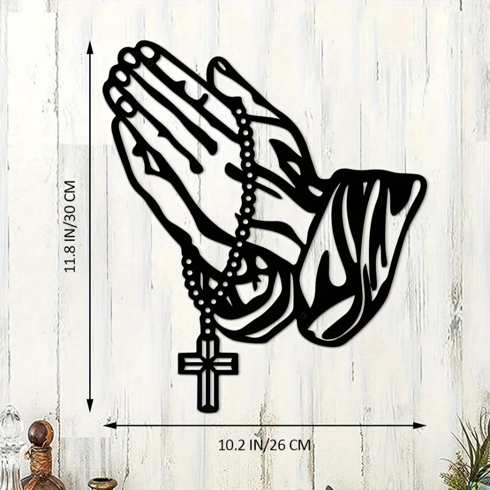Black silhouette of an open hand holding a prayer cross, metal wall art for Christian decor