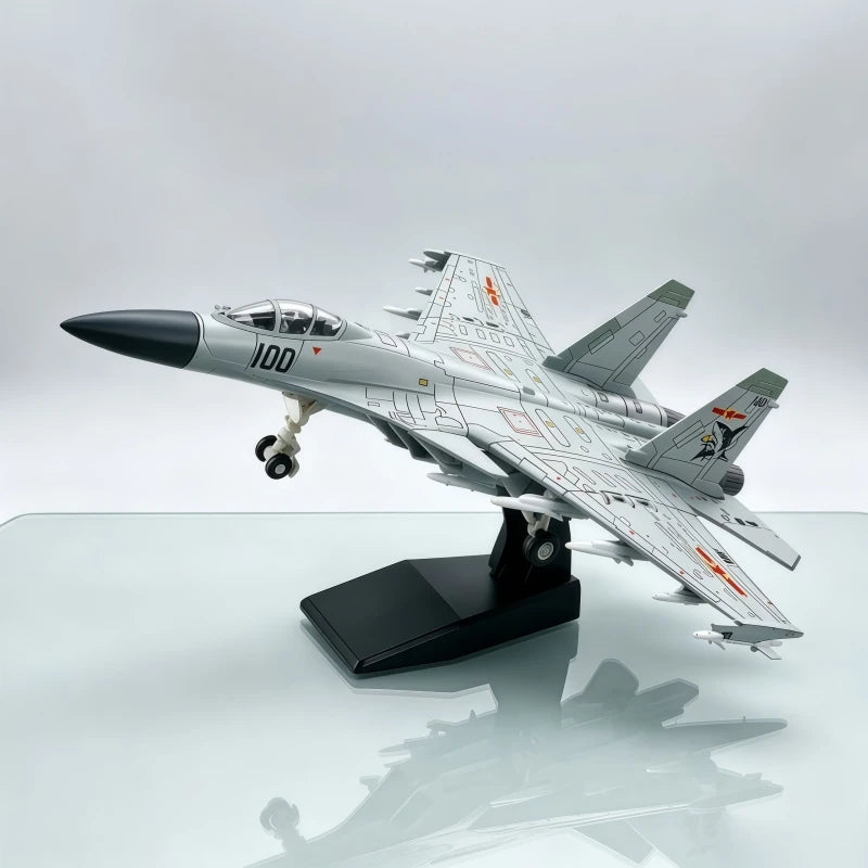 A detailed model of a J-15 fighter jet in a silver and gray camouflage scheme displayed on a black stand.