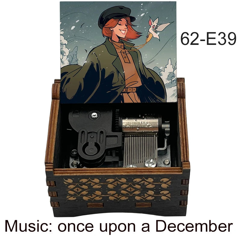A hand-cranked wooden music box featuring an illustration of a woman and a bird, labeled 62-E39.
