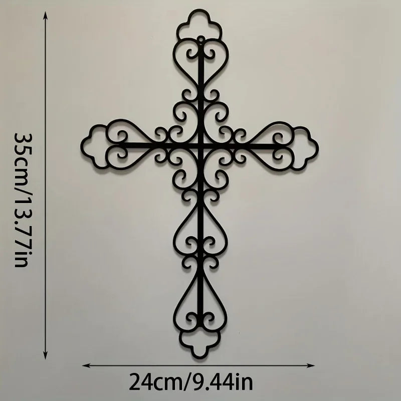 Black metal cross wall decor with ornate scrollwork, measuring 24cm by 35cm.