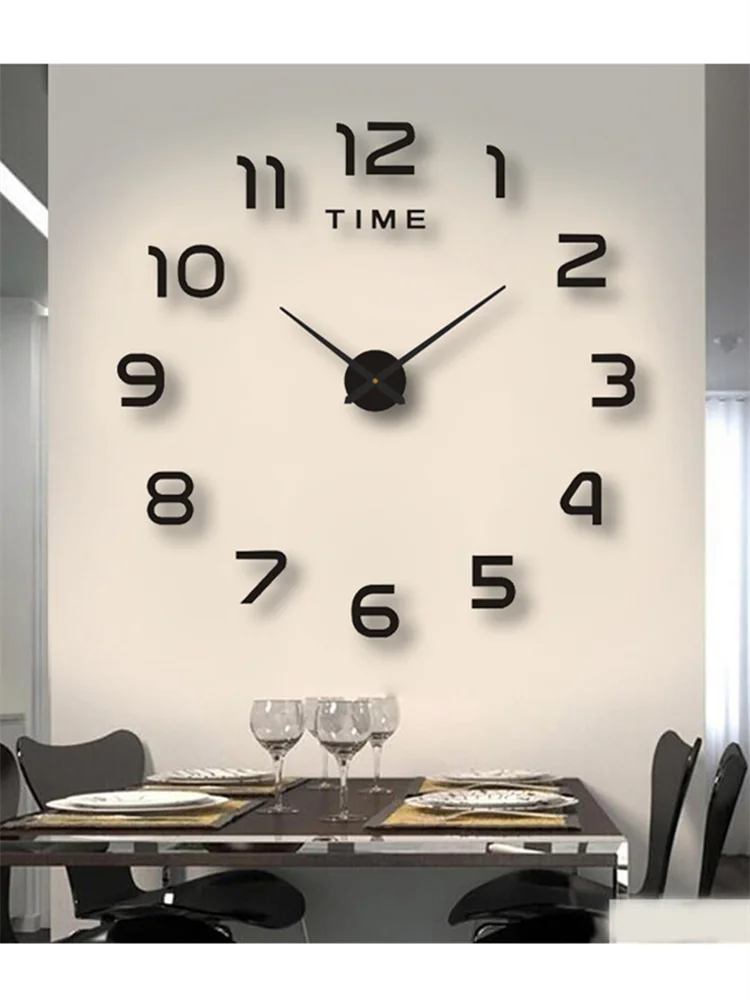 A modern black wall clock with silver hands and numbers on a white wall above a dining table.