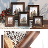 A set of vintage resin photo frames in dark wood tones displayed on a wooden surface with natural light and shadows.