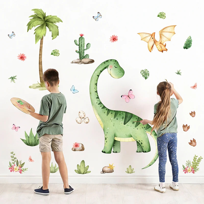A young boy and girl are decorating a white wall with large green dinosaur stickers.