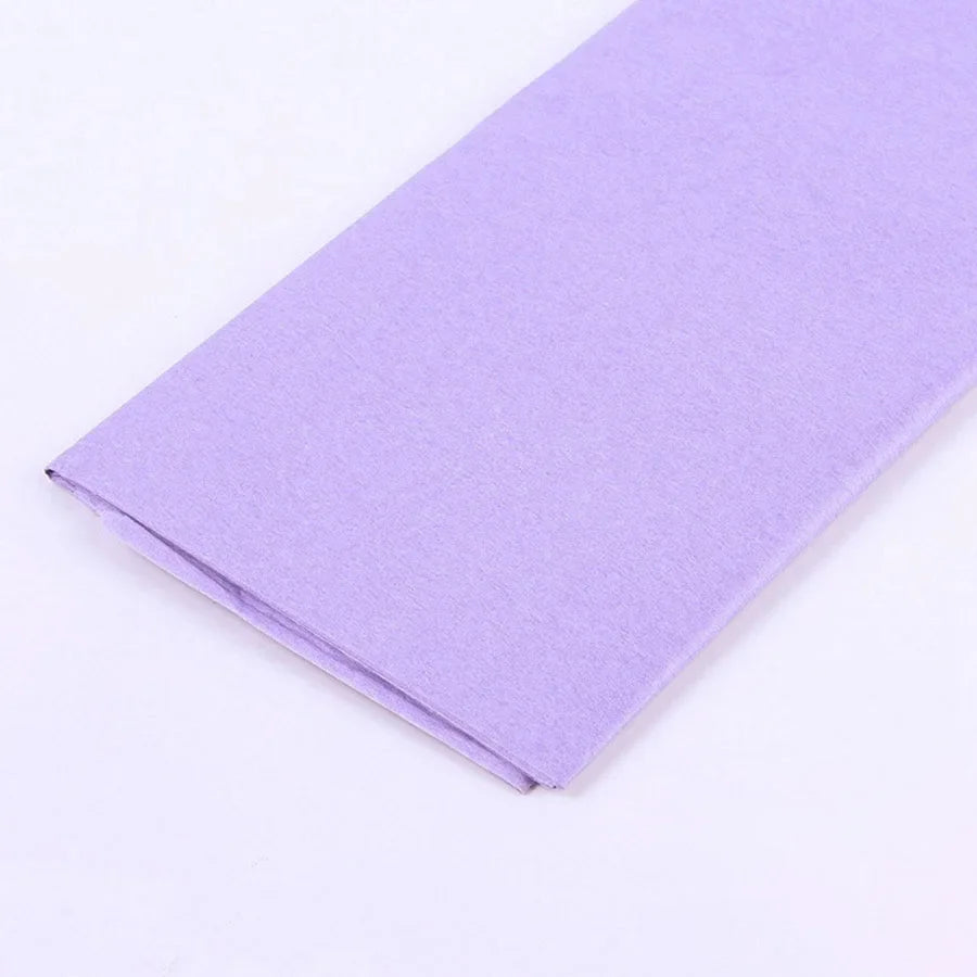 A purple soft tissue paper sheet folded diagonally on a white background.