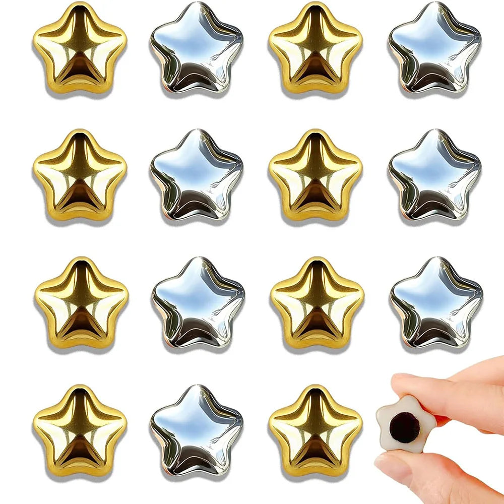 A set of fifteen gold star fridge magnets with silver accents.