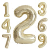 A set of large champagne gold foil number balloons forming the numbers 1 through 9.