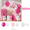 A large arrangement of pink and white balloons used for a baby party decoration set