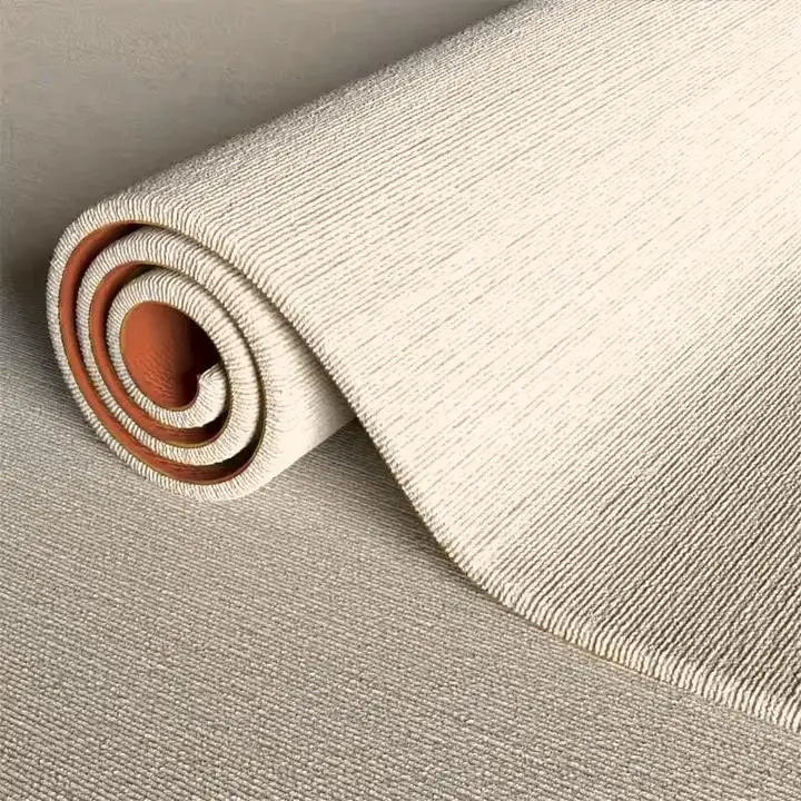A roll of beige artificial grass carpet for outdoor decor, showing the texture and rolled form.