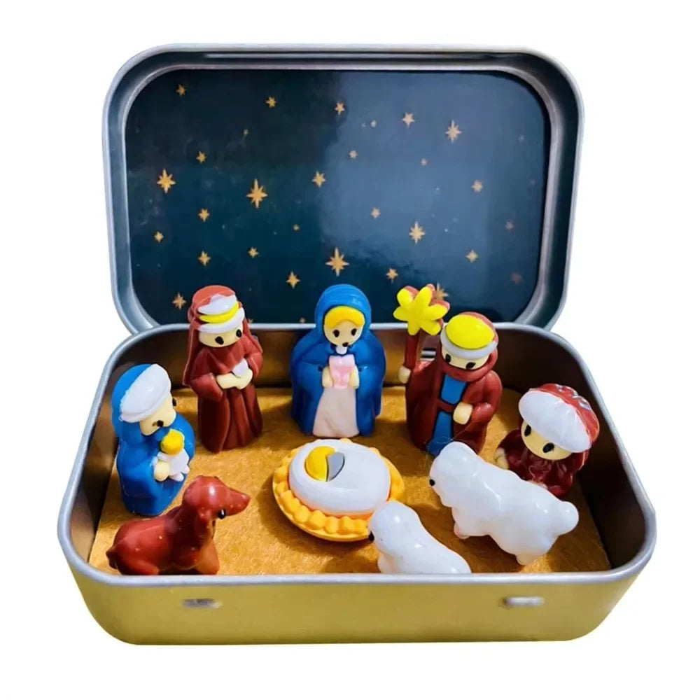 A set of classic PVC Christmas nativity scene figurines, including Mary, Joseph, and baby Jesus, displayed in a storage tin.
