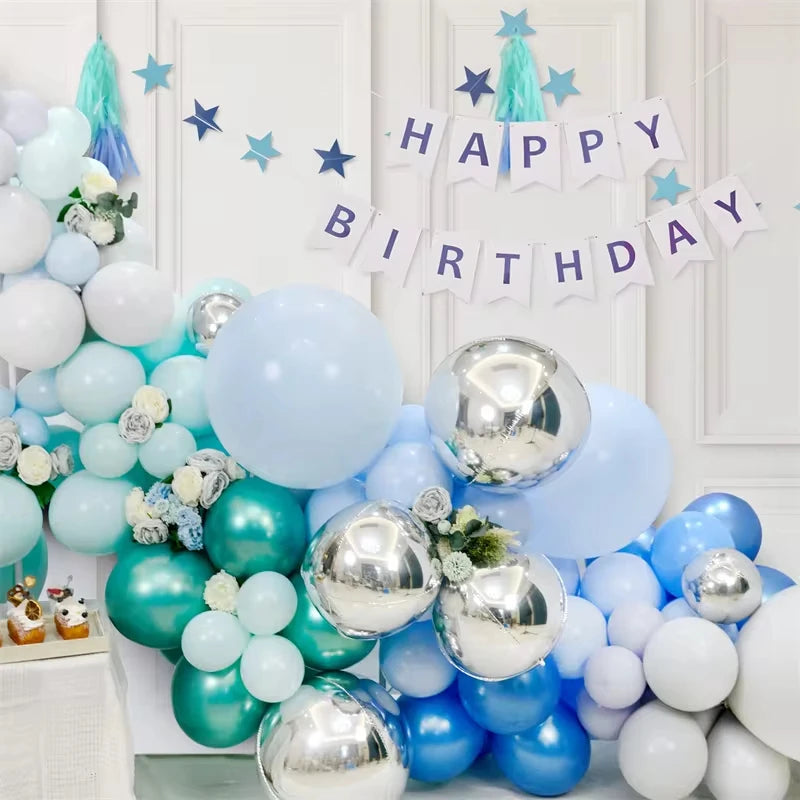 A collection of metallic chrome balloons in various sizes and shades of blue and white, decorated with a happy birthday banne
