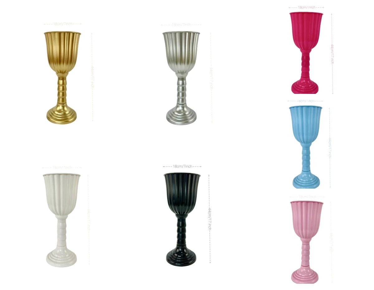 A collection of elegant cylinder flower vases in gold, silver, white, black, and pink.