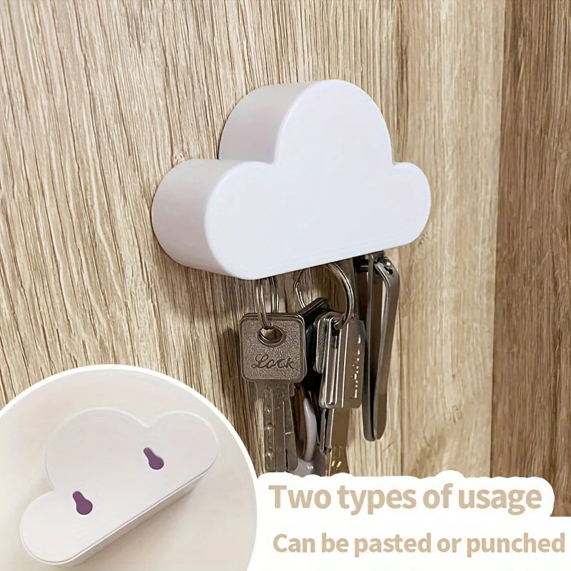 A white magnetic cloud key hanger with multiple keys hanging from it, showing two types of usage options.