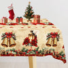 Vintage Christmas tablecloth featuring poinsettia leaves and brass bells.