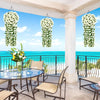 Artificial violet ivy hanging garland displayed outdoors on a balcony with a view of the ocean