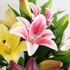 A bouquet of realistic silk lily flowers in shades of pink, white, and yellow with green stems.