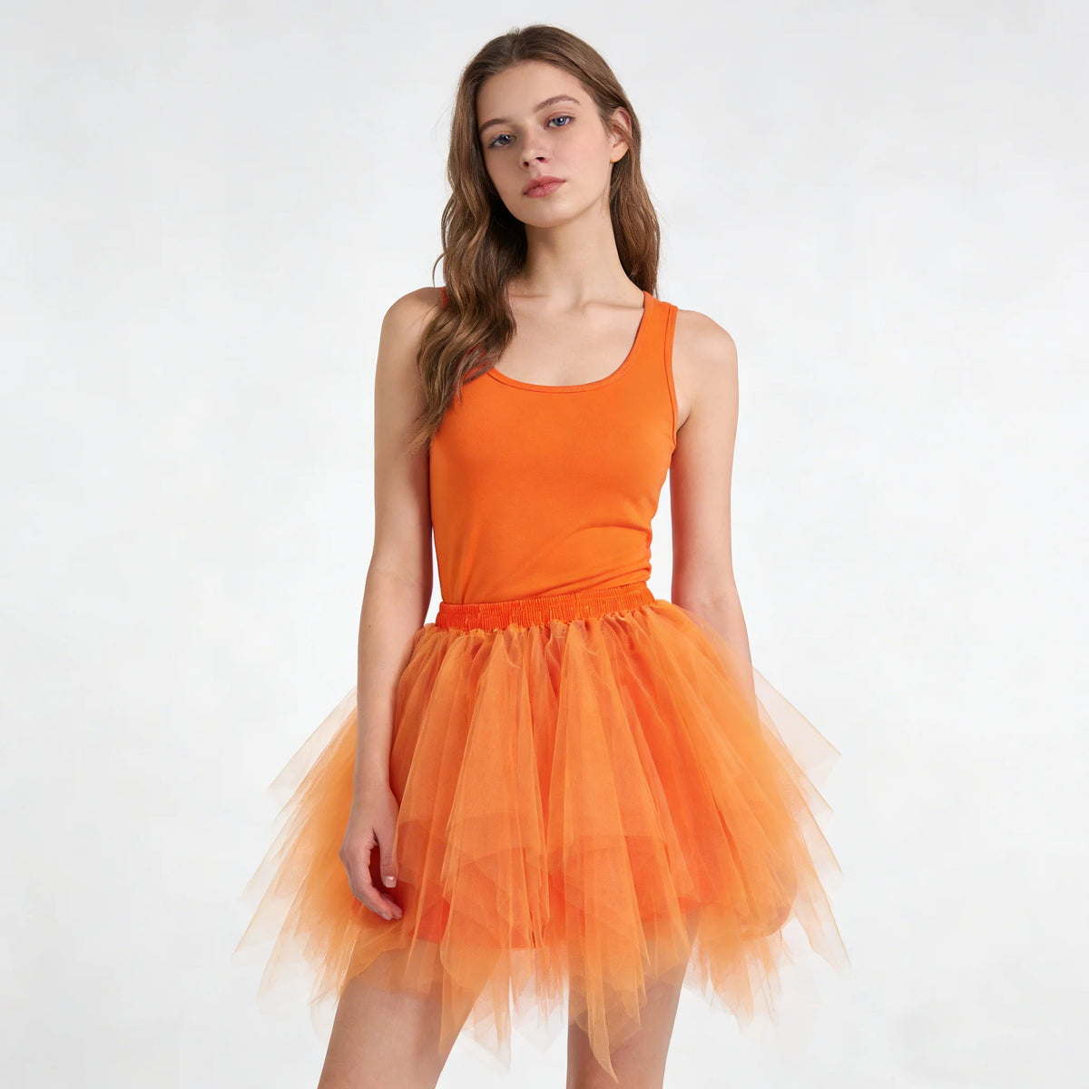 A young woman models an orange sleeveless top and a matching orange tulle tutu skirt.