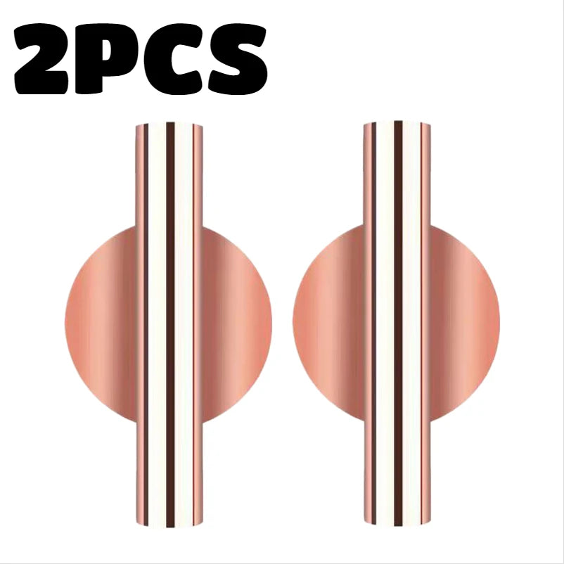 Two modern wall-mounted flower vases with a rose gold finish and striped design.