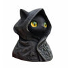 A dark, sculpted statue of a cat wearing a hood, featuring glowing yellow eyes.
