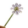 Handcrafted blue glass flower sculpture with a green stem and yellow center