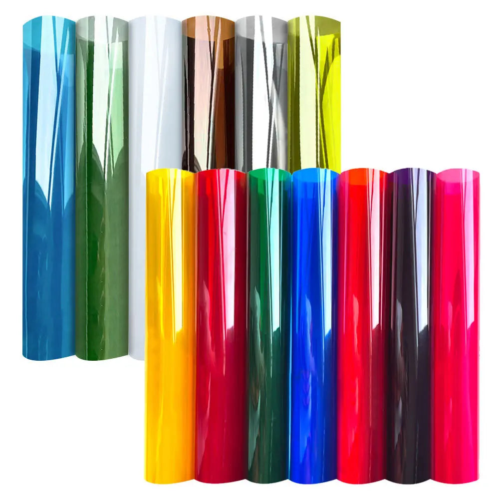 A collection of vertical decorative stained glass window film rolls in various vibrant colors including blue, green, yellow, 