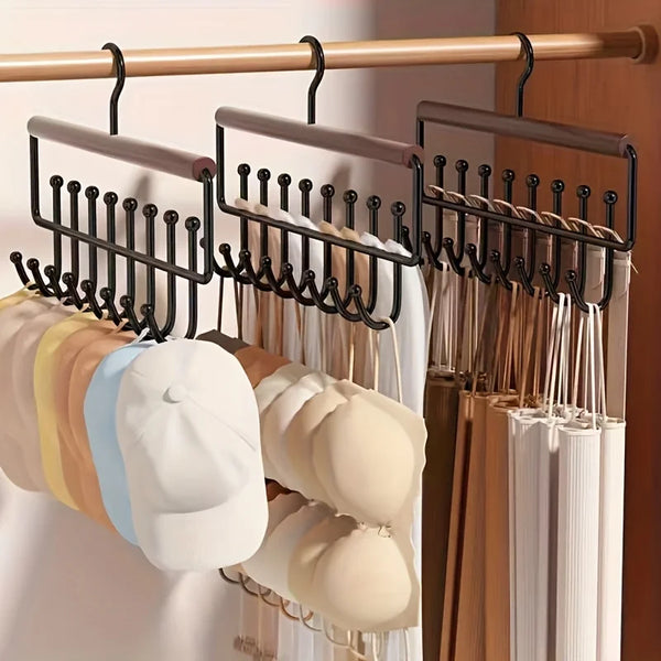 Wall-mounted metal coat rack with eight hooks displaying various colored coats and jackets.