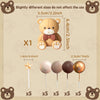 A set of five brown spherical cake toppers on sticks, with dimensions and a bear for scale.