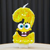 A SpongeBob character shaped birthday candle number 2 made of yellow glittery cake.