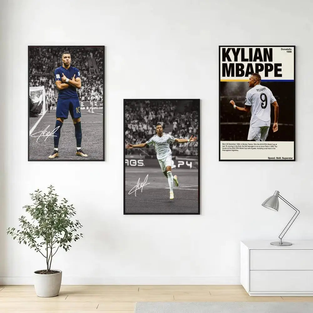 A gallery wall featuring three black and white sports posters of Kylian Mbappé in soccer uniforms.