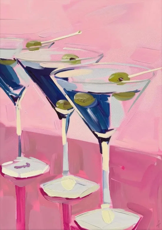 Three martini glasses filled with blue liquid and green olives on pink surfaces