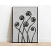 Black and white abstract art featuring swirling, organic lines and spherical shapes on a canvas.