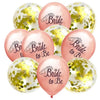 A pack of ten rose gold latex confetti balloons with bride themes and gold glitter accents