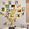 A decorative wall art set featuring a family tree design with various framed photos and gold leaf accents.