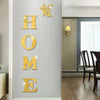 Gold acrylic wall stickers spelling HOME with a butterfly design