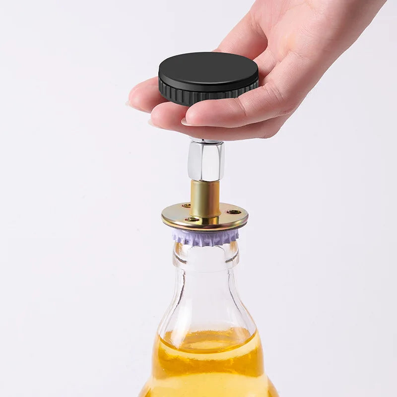 A hand holds a black adjustable bed stabilizer device above a glass bottle containing an amber liquid.