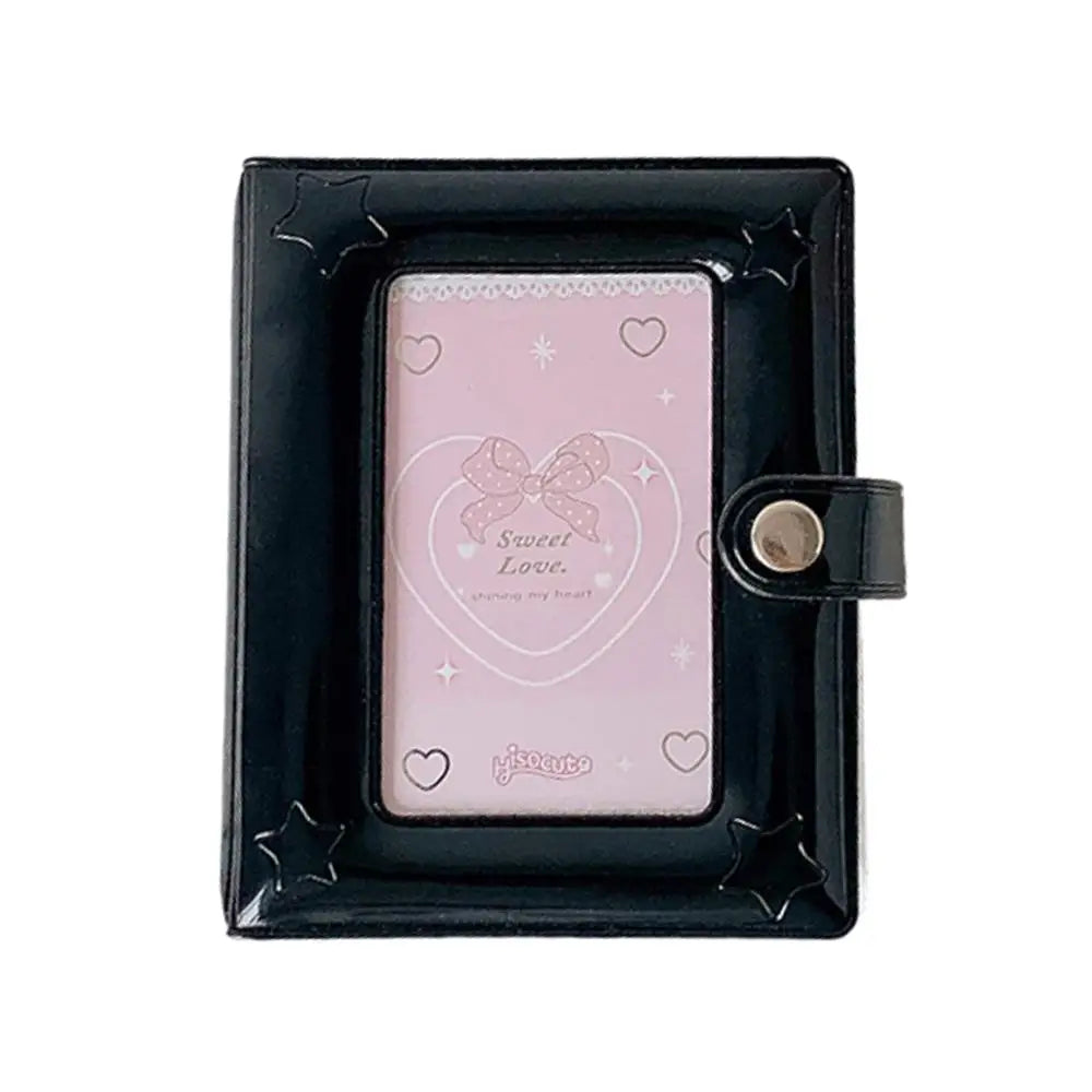 A black compact star-shaped photo card holder album with a pink insert and a bow design.