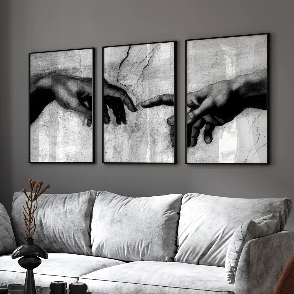 Three framed black and white canvas prints depicting hands in a spiritual theme