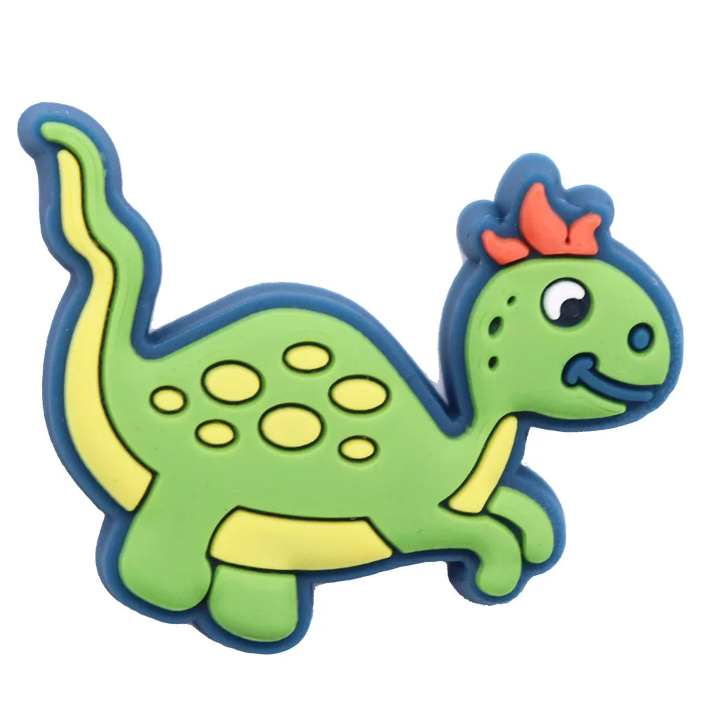 A set of twelve green and yellow cartoon dinosaur PVC shoe charms with orange horns