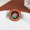 An enamel pin featuring a green dumpster engulfed in flames with the text Dumpster Fire Response Team