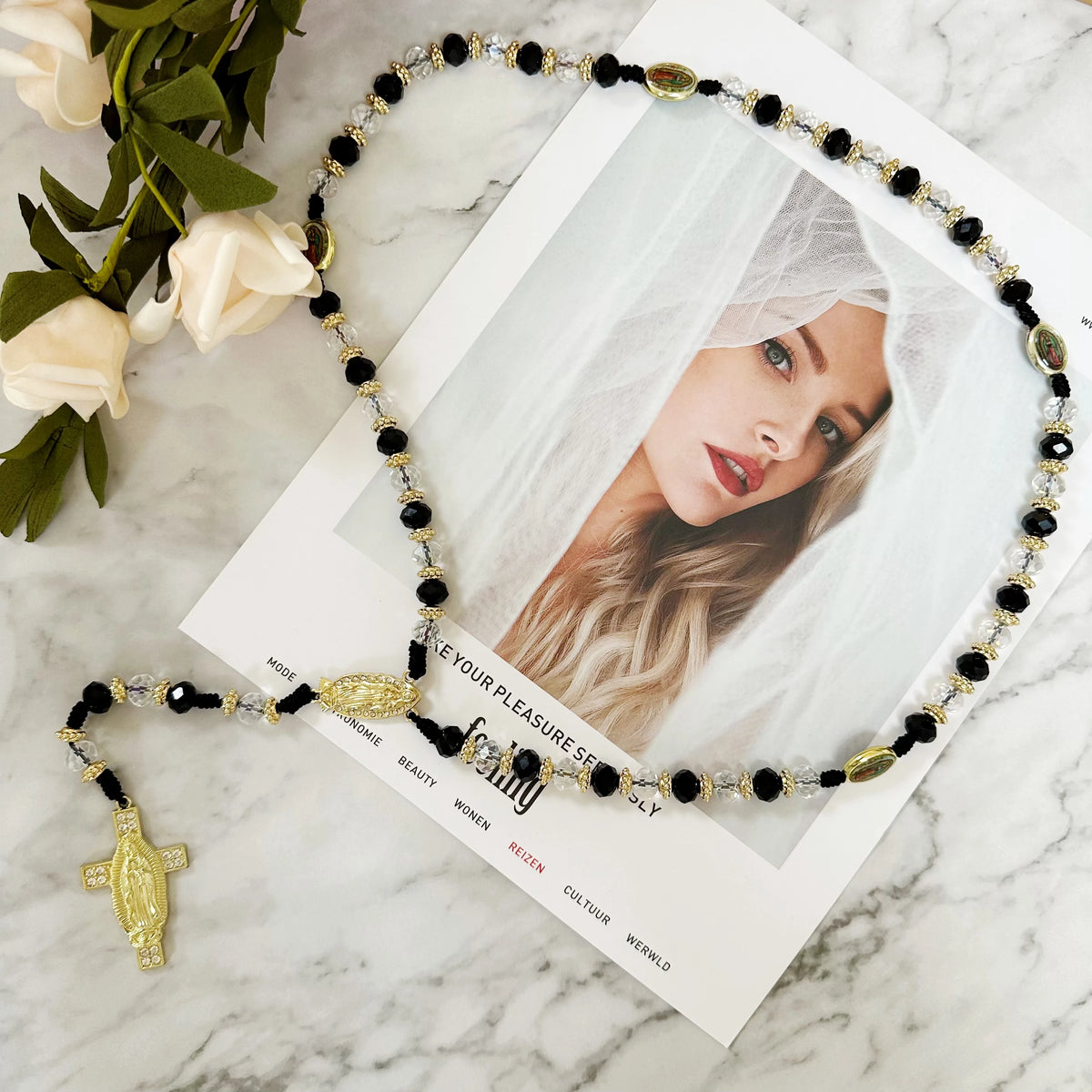 A green crystal rosary necklace with a Saint Jude and Virgin Mary cross pendant displayed on a white background.