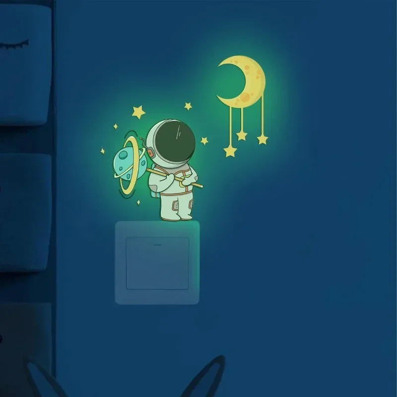 Wall stickers featuring an astronaut, stars, and a crescent moon against a dark blue background.