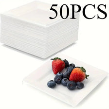 A stack of 50 white square paper plates next to a serving platter of fresh strawberries and blueberries.