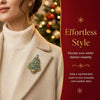 A close-up of a woman wearing a beige turtleneck sweater and blazer with a rhinestone Christmas tree brooch pin.