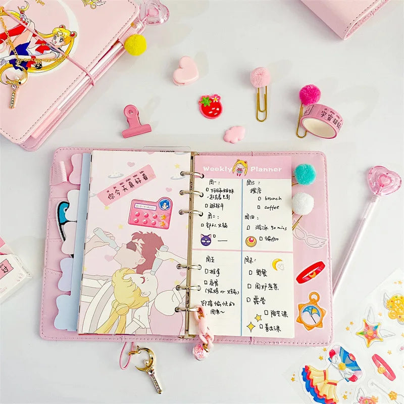 A pink luxury heart pendant diary set with planner pages and decorative accessories is displayed on a white surface.