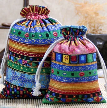 A colorful set of vintage cotton drawstring gift pouches featuring geometric patterns in various bright colors.