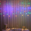LED butterfly curtain lights hanging in a vertical drape with various colored lights