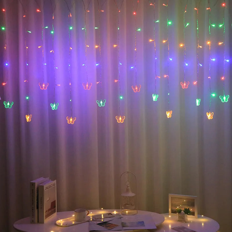 LED butterfly curtain lights hanging in a vertical drape with various colored lights