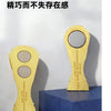 A gold-colored fridge magnet shaped like a soccer trophy, featuring a reflective surface.