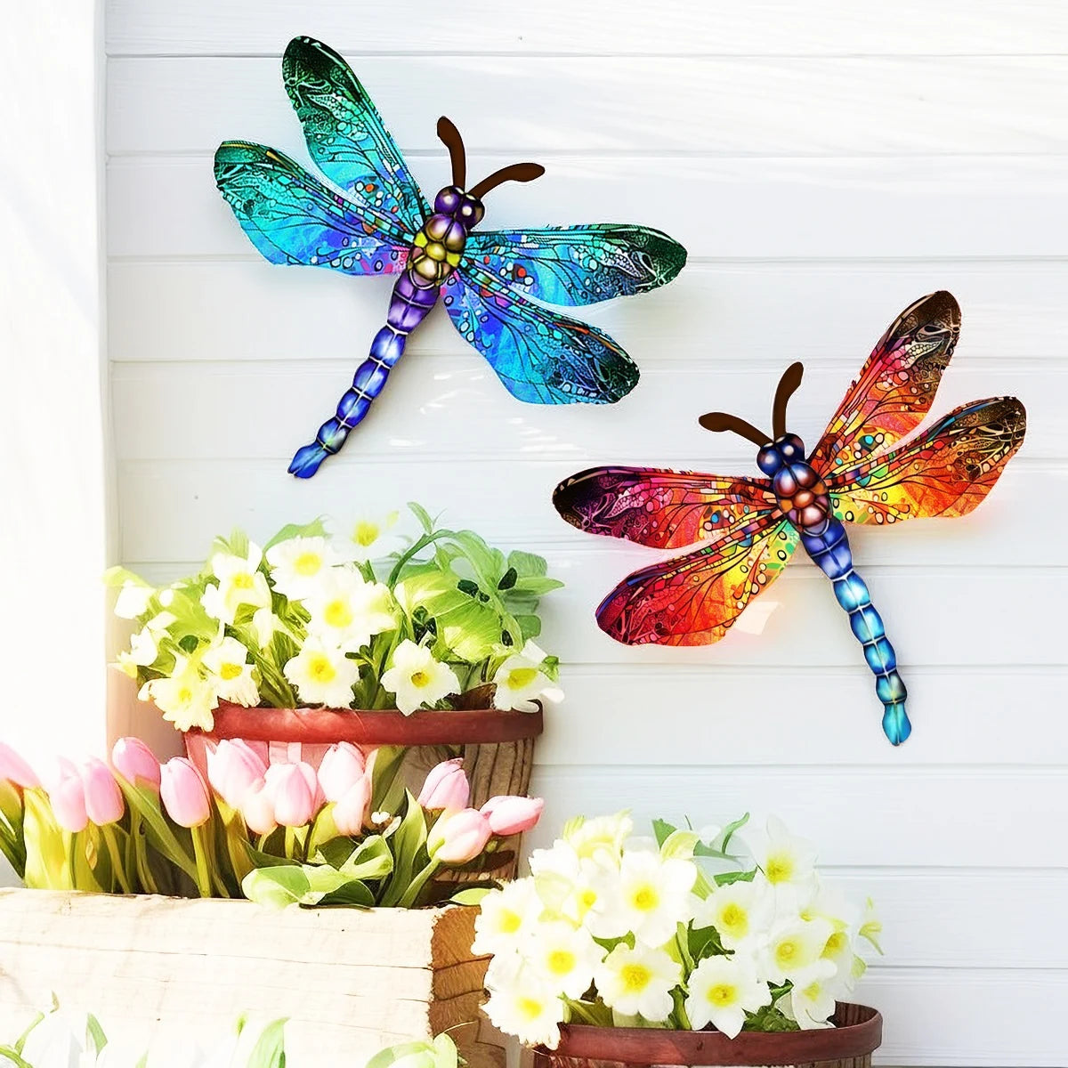 Vintage dragonfly wall art sculpture with iridescent blue and green wings displayed above pink and white tulips.